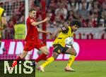 12.04.2025, Fussball 1. Bundesliga 2024/2025, 29. Spieltag,  FC Bayern Mnchen - Borussia Dortmund, in der Allianz-Arena Mnchen. von links:  Josip Stanisic (Bayern Mnchen) gegen Karim Adeyemi (Borussia Dortmund) 