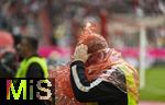 02.08.2025, Fussball Bundesliga 2025/2026, Freundschaftsspiel, FC Bayern Mnchen - Olympique Lyon, in der Allianz-Arena Mnchen, Ordner am Spielfeldrand beim Versuch sich das Regencape berzustreifen.